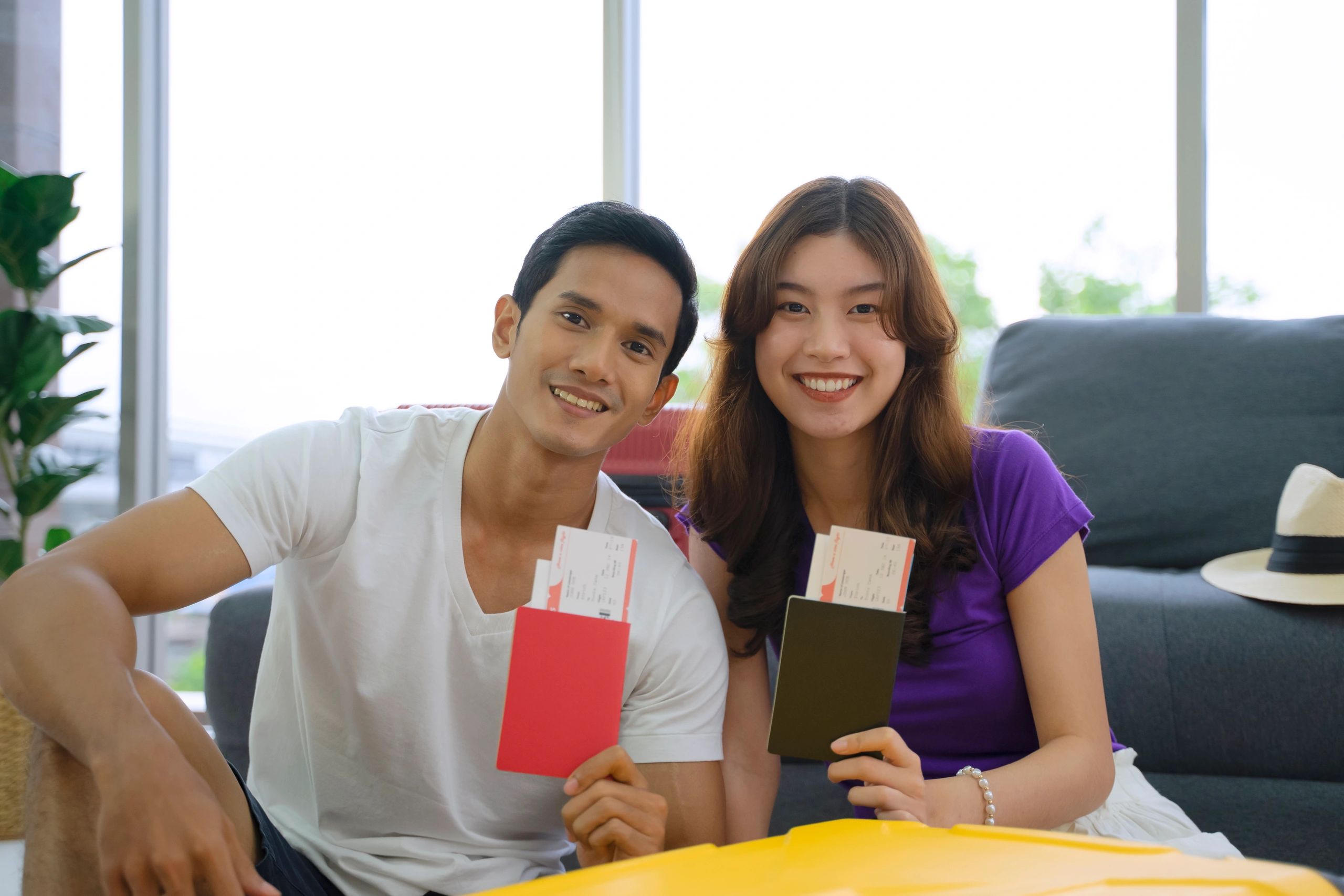 Couple reviewing travel documents and passport information
