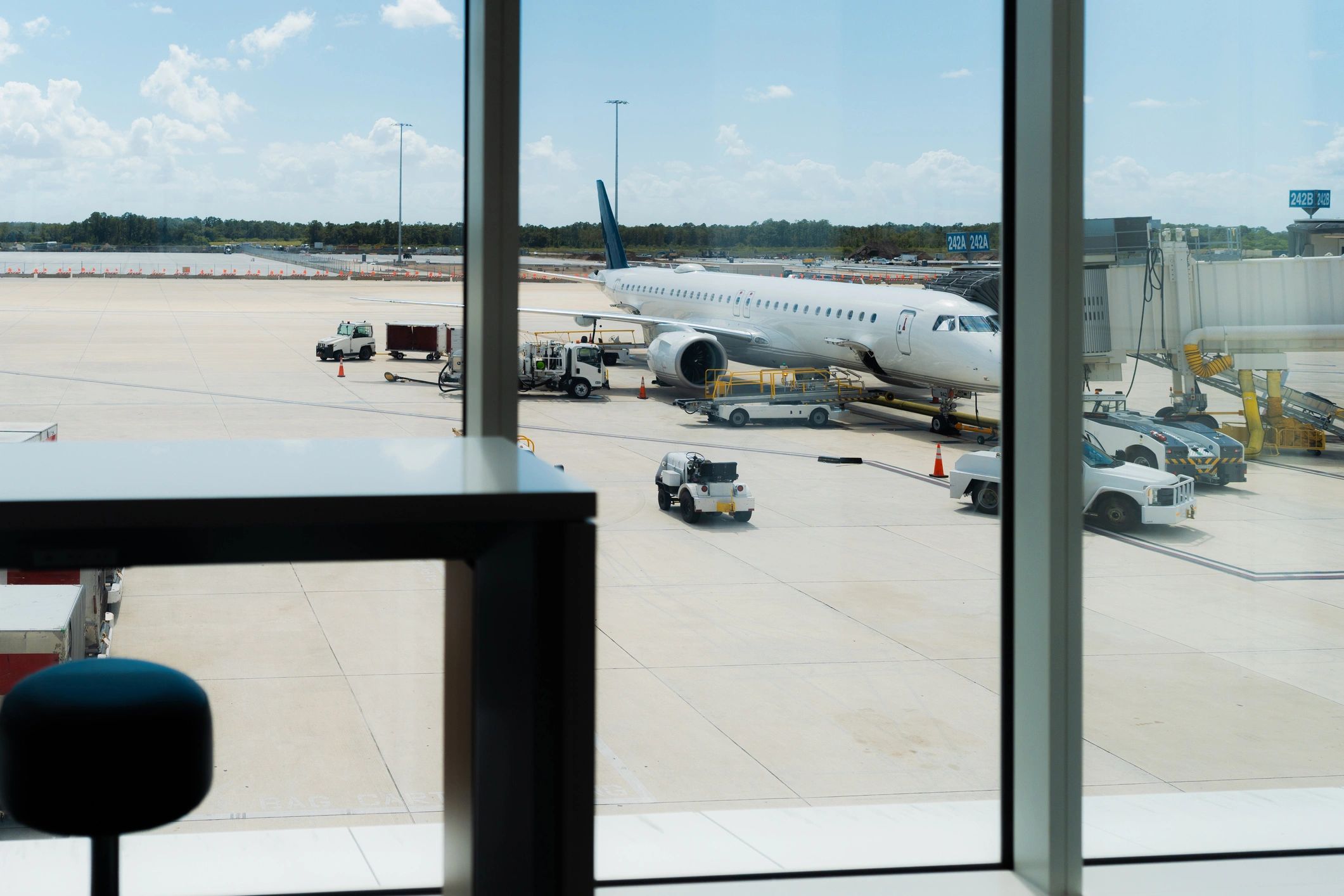 Airport terminal view overlooking airplane and tarmac