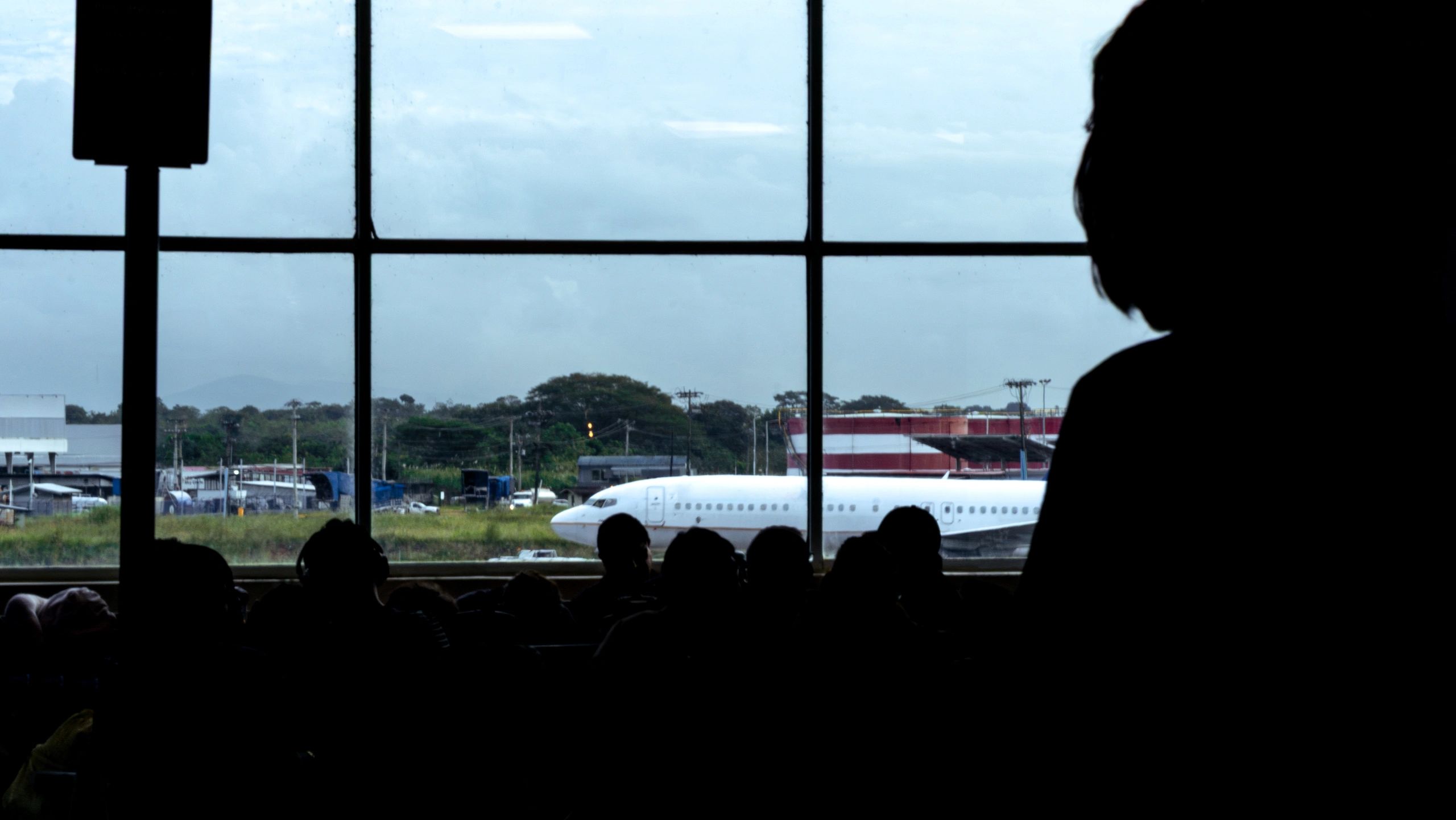 Travelers waiting in an airport terminal
