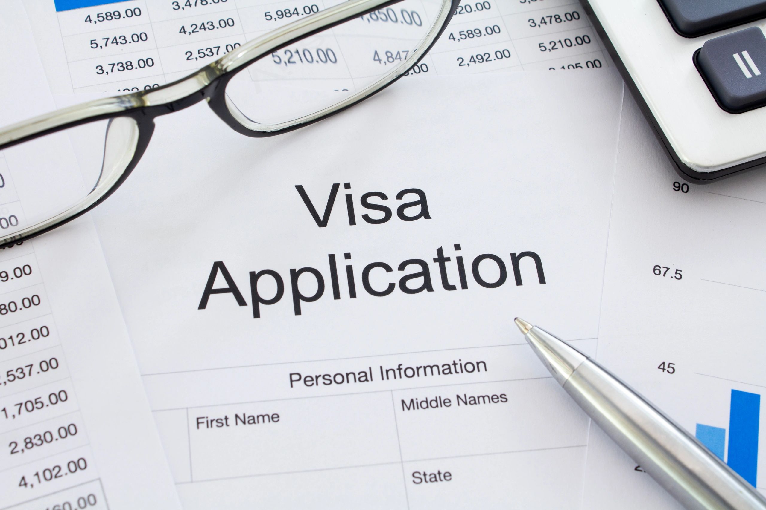 Visa application form and supporting documents on a desk